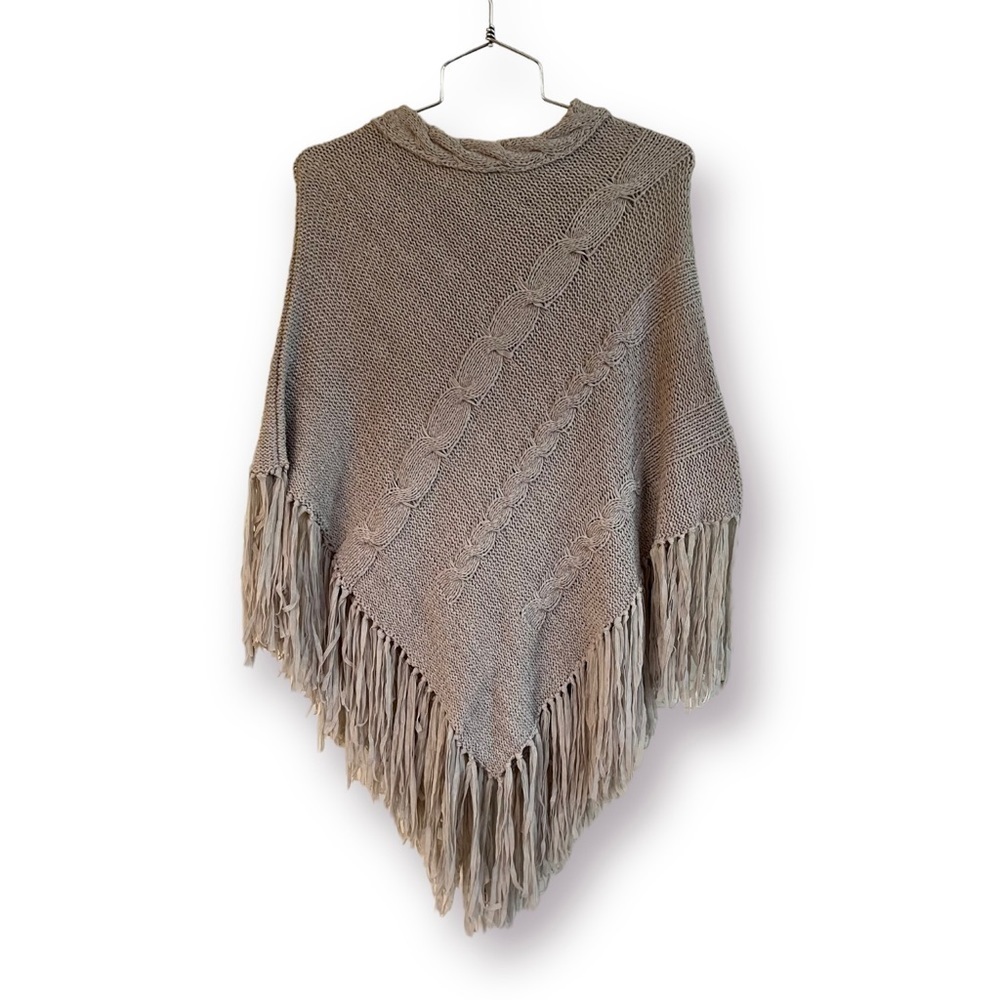 SWEATER PONCHO. 59% ACRYLIC, 41% NYLON. CABLE NECK & NYLON FRINGE AT BOTTOM. OS.